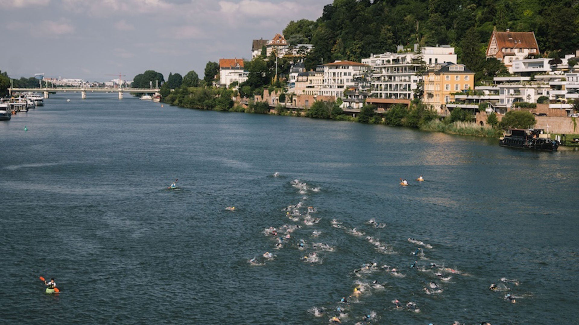 Aerial view of the Heidelberg Triathlon swim course on the Neckar River with athletes spread across the water.