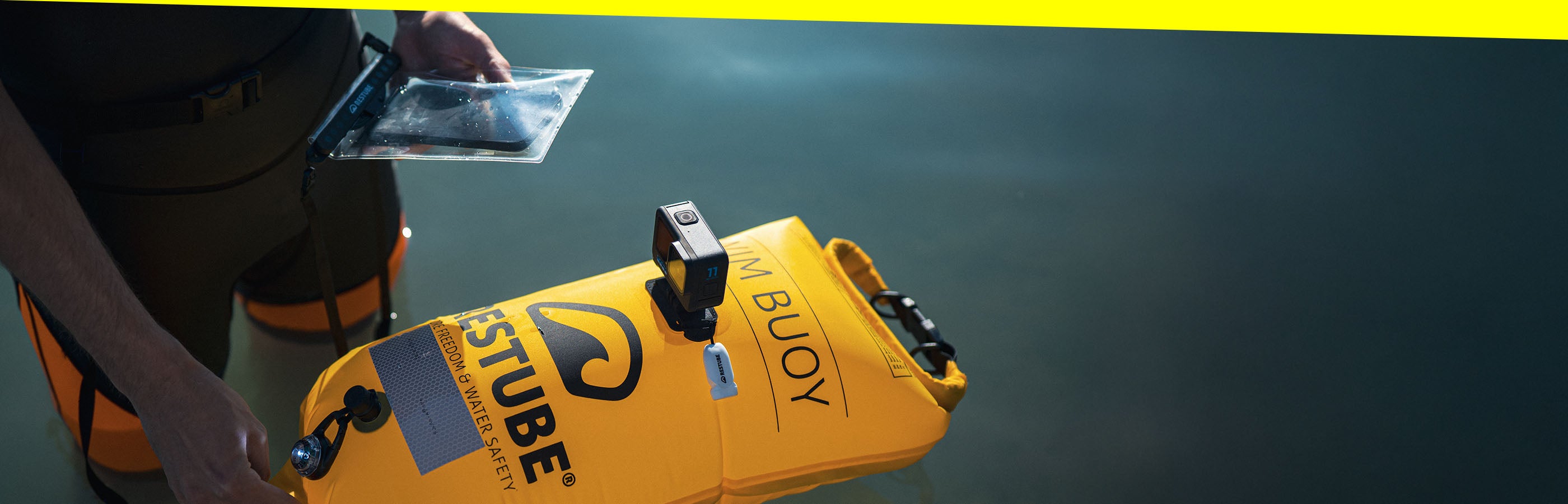 RESTUBE swim buoy with LED light and action camera, and waterproof phone case in action.