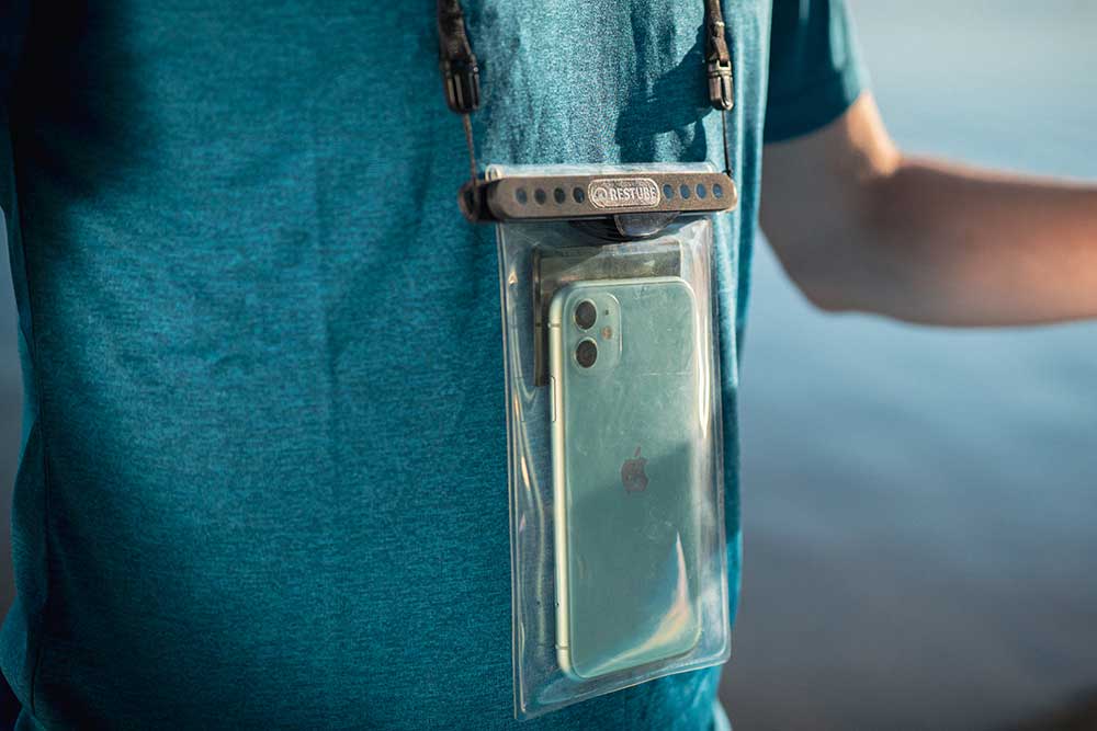 Waterproof phone case by RESTUBE worn around the neck – perfect for watersports.