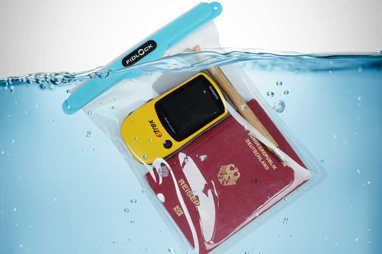 Waterproof pouch with a GPS device, a wooden pen and a passport submerged underwater.