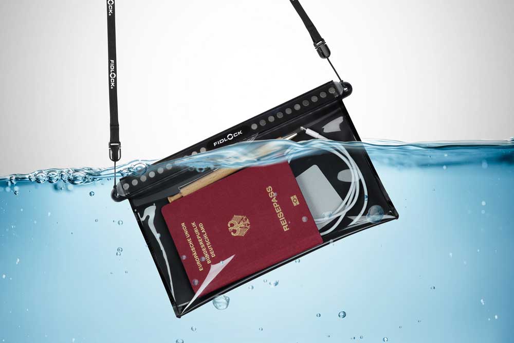 A waterproof pouch with passport and cables inside, fully submerged underwater – ideal for water safety and outdoor use.