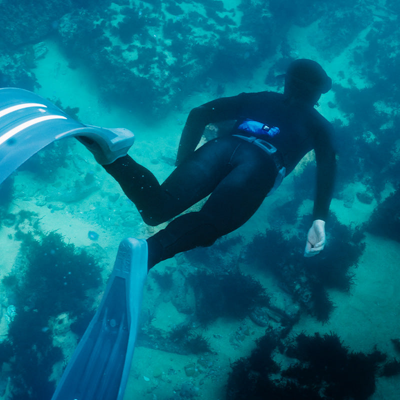 A diver with RESTUBE buoy in the sea – for safety and flotation.