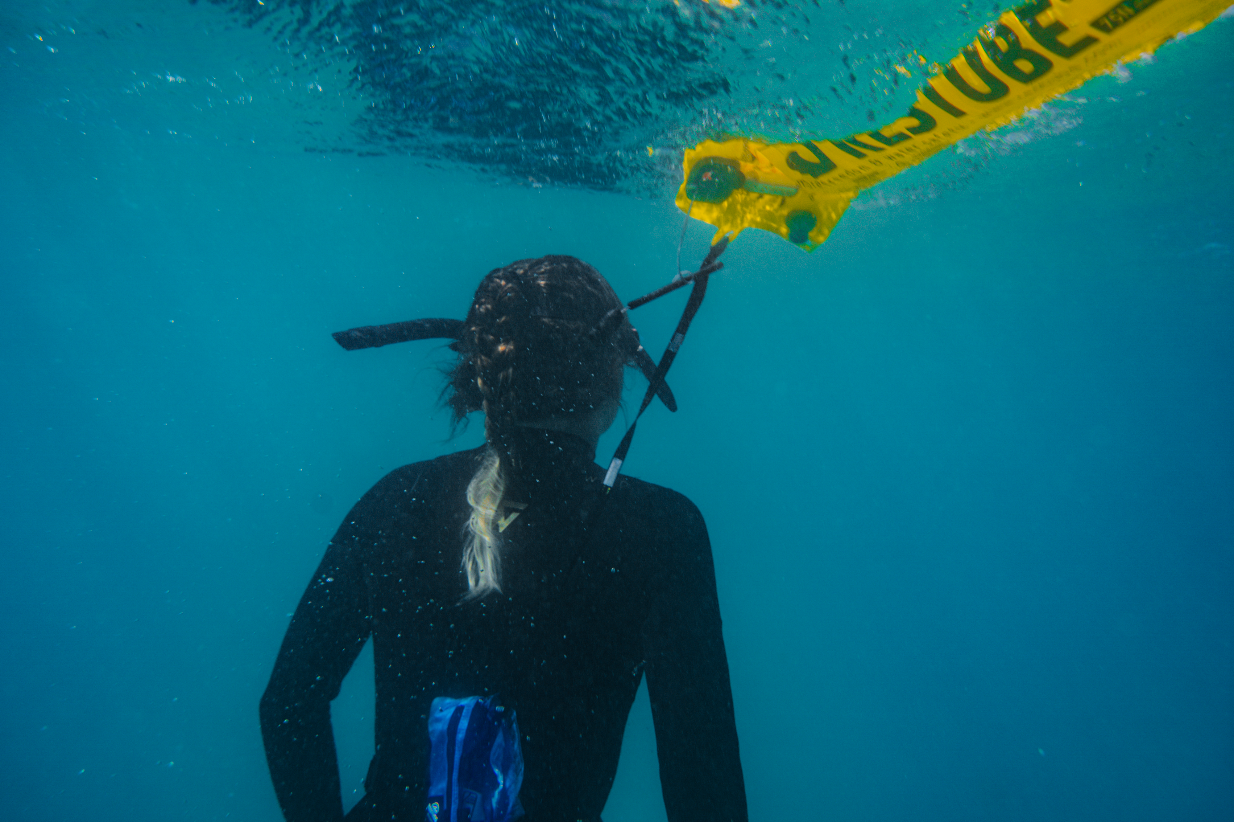 A diver with RESTUBE buoy floating above her in open water – for enhanced safety and visibility.
