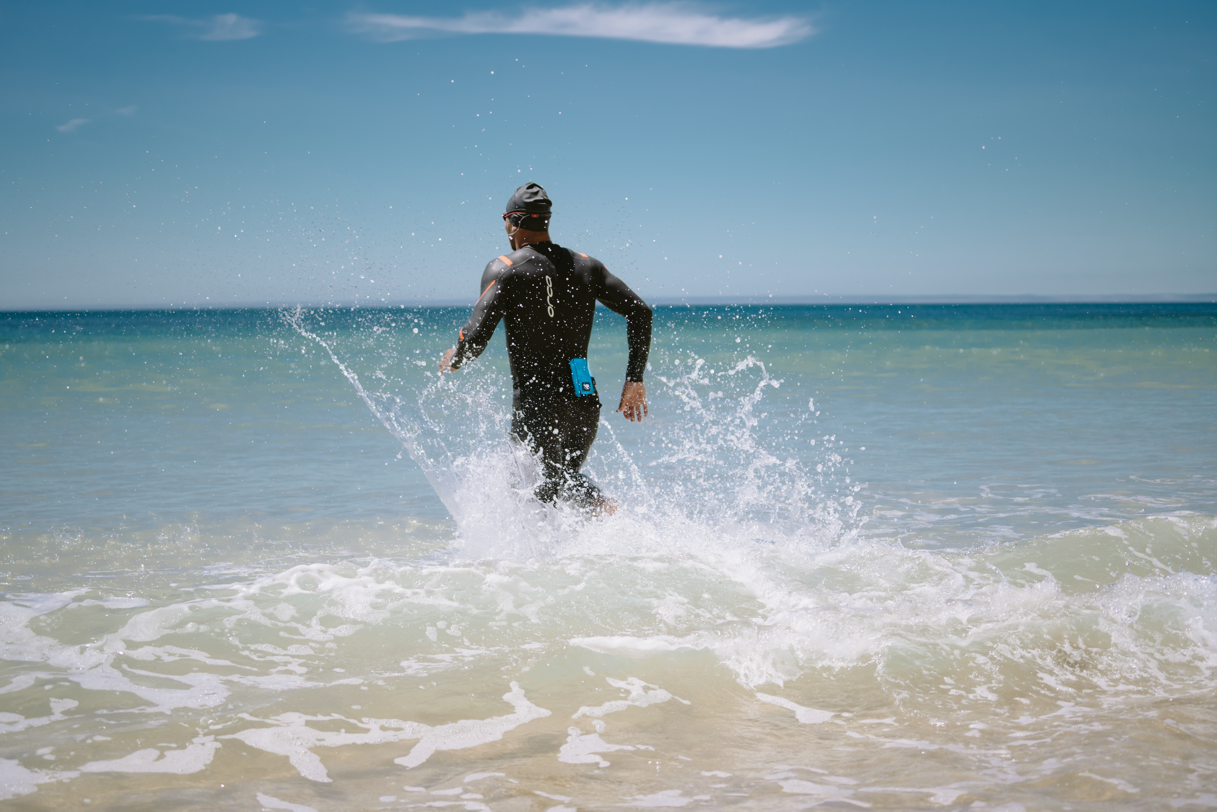 Watersports enthusiast in the ocean with RESTUBE buoy – for flotation and safety.