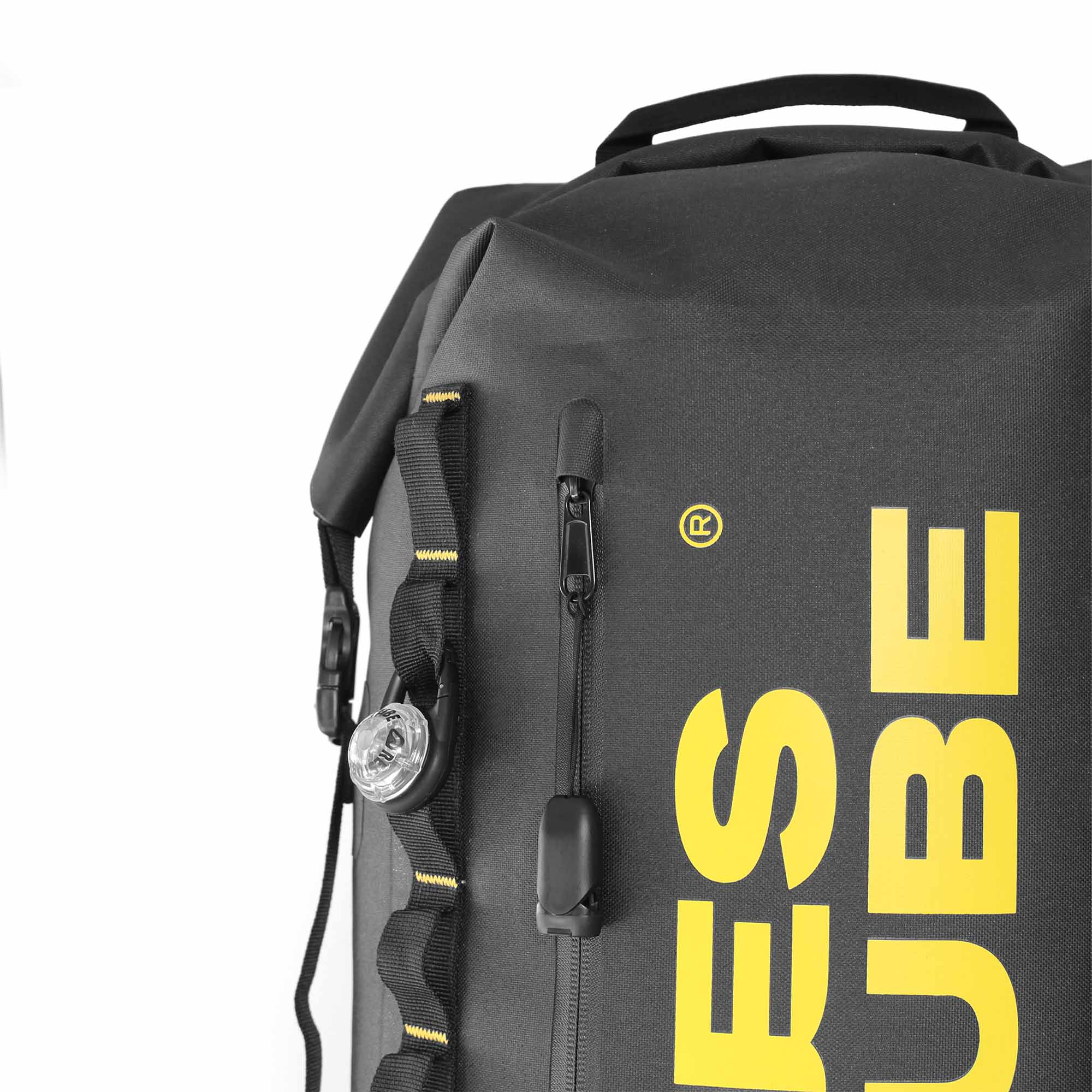 Close-up of waterproof front pocket and attachment loops on roll-top backpack