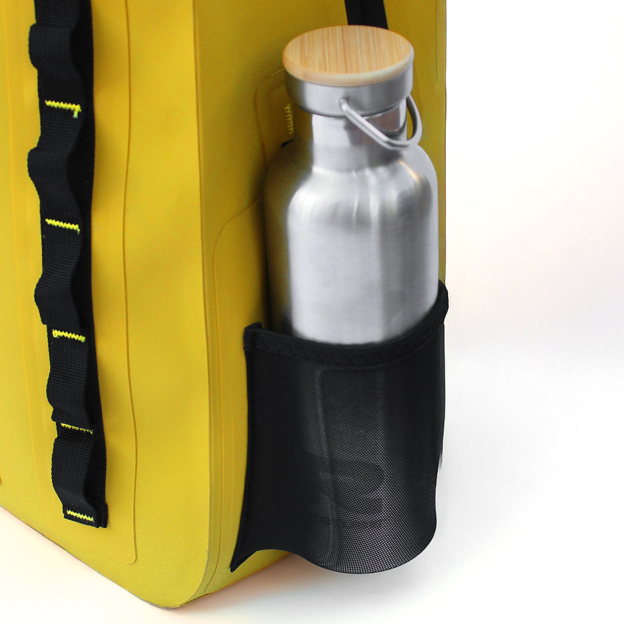 Reusable metal water bottle stored in elastic side pocket of yellow waterproof backpack