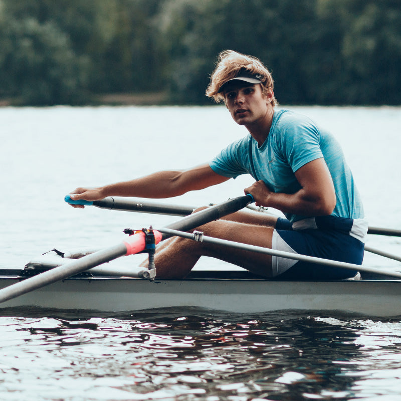 Rower with RESTUBE safety buoy on a lake – ready for water-based activities.