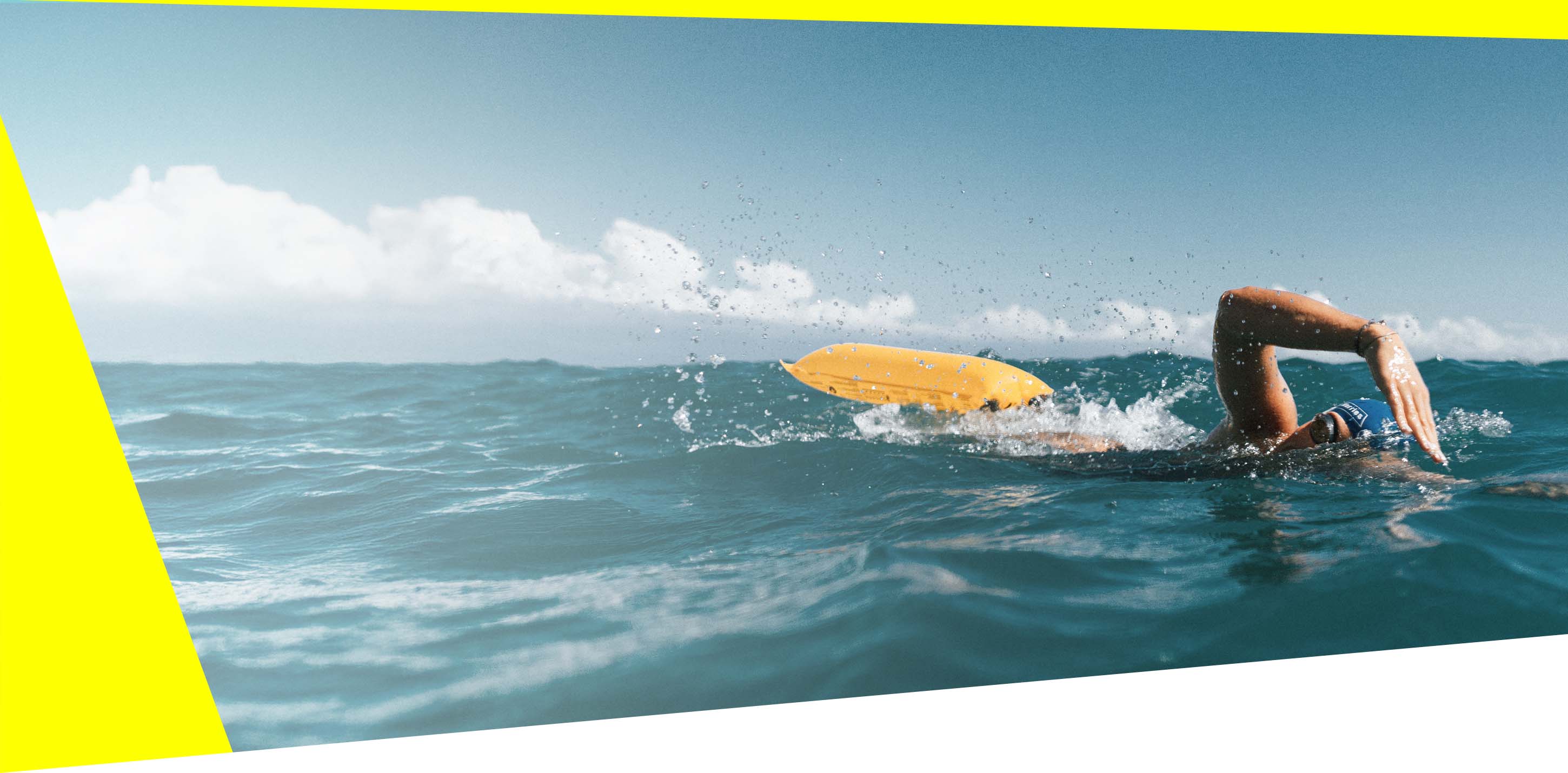 A swimmer with inflatable RESTUBE buoy in open sea – for added safety.