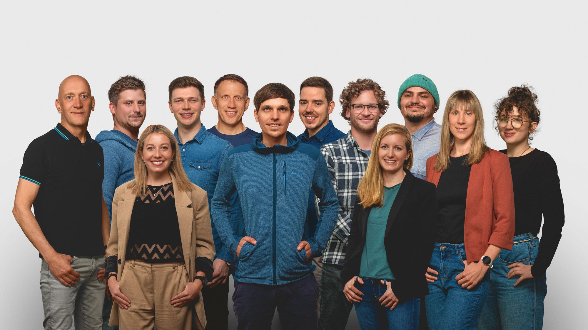 RESTUBE team members in front of a neutral background.