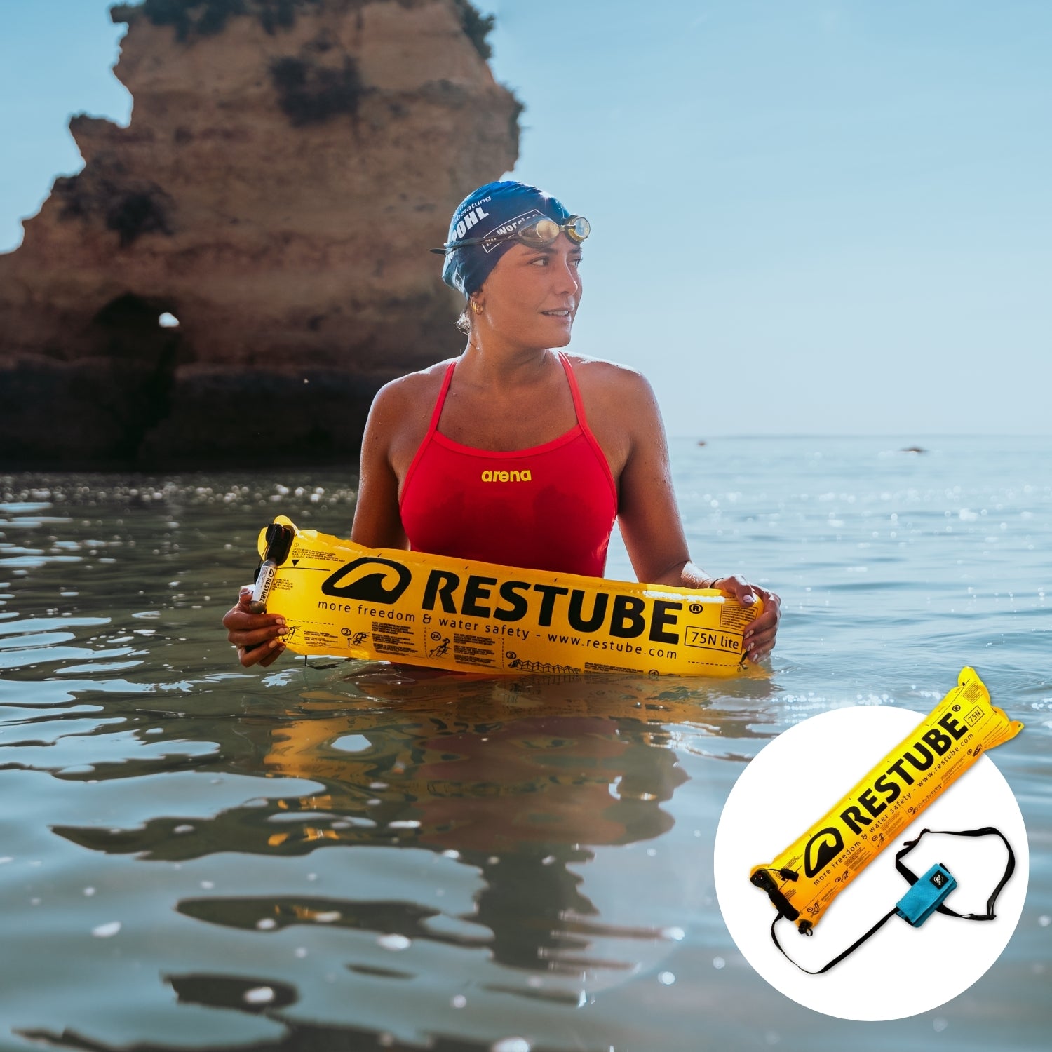 Female watersports athlete with RESTUBE safety buoy in the sea with a lonely tall rock at the background