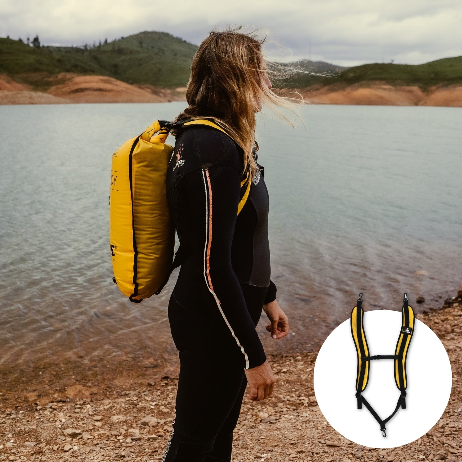 Female watersports athlete with yellow RESTUBE swim buoy strapped to her back with the special rucksack-like straps by the lake