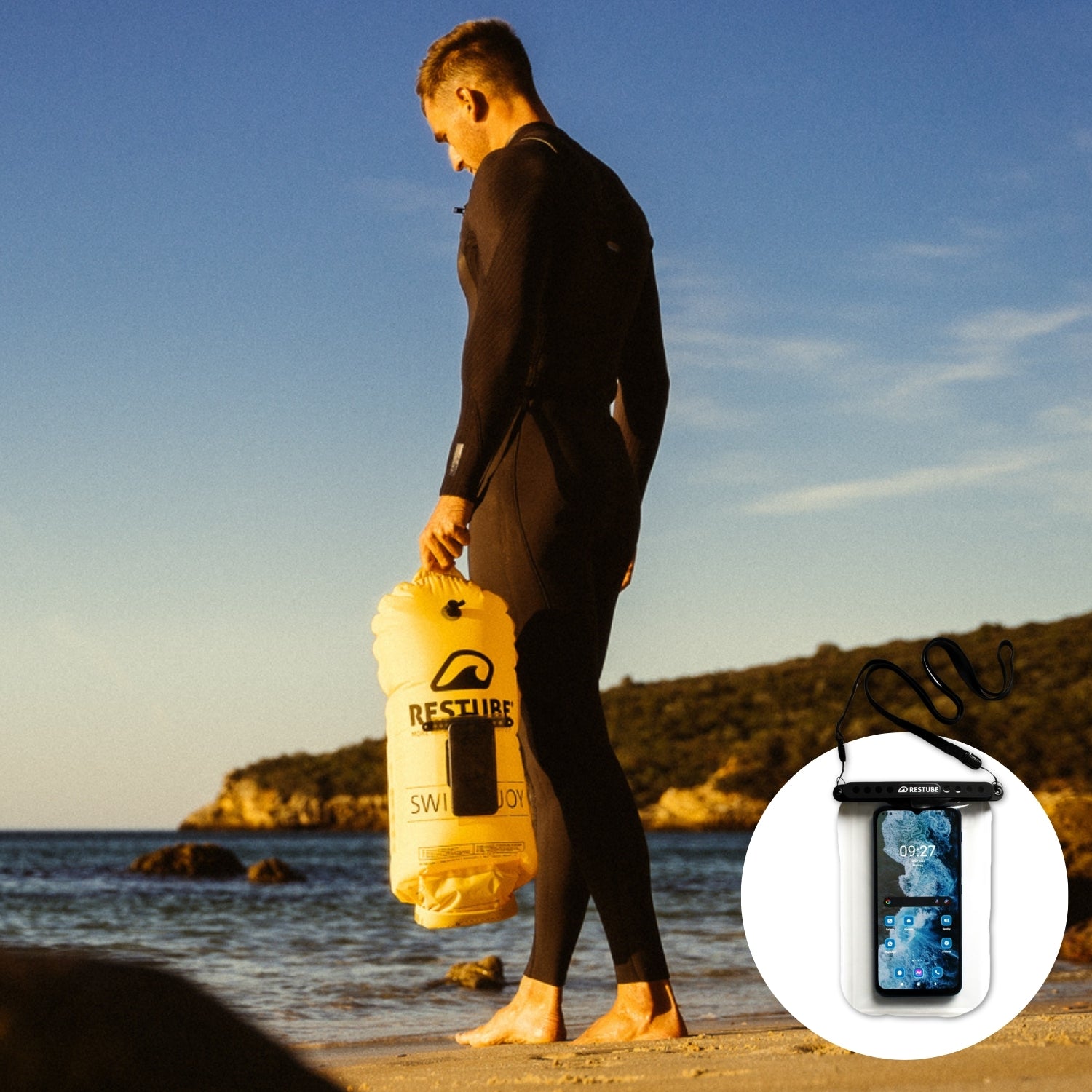 Watersports athlete with RESTUBE buoy on the beach going into the water, the waterproof phone case stuck safely to the swim buoy with the phone inside