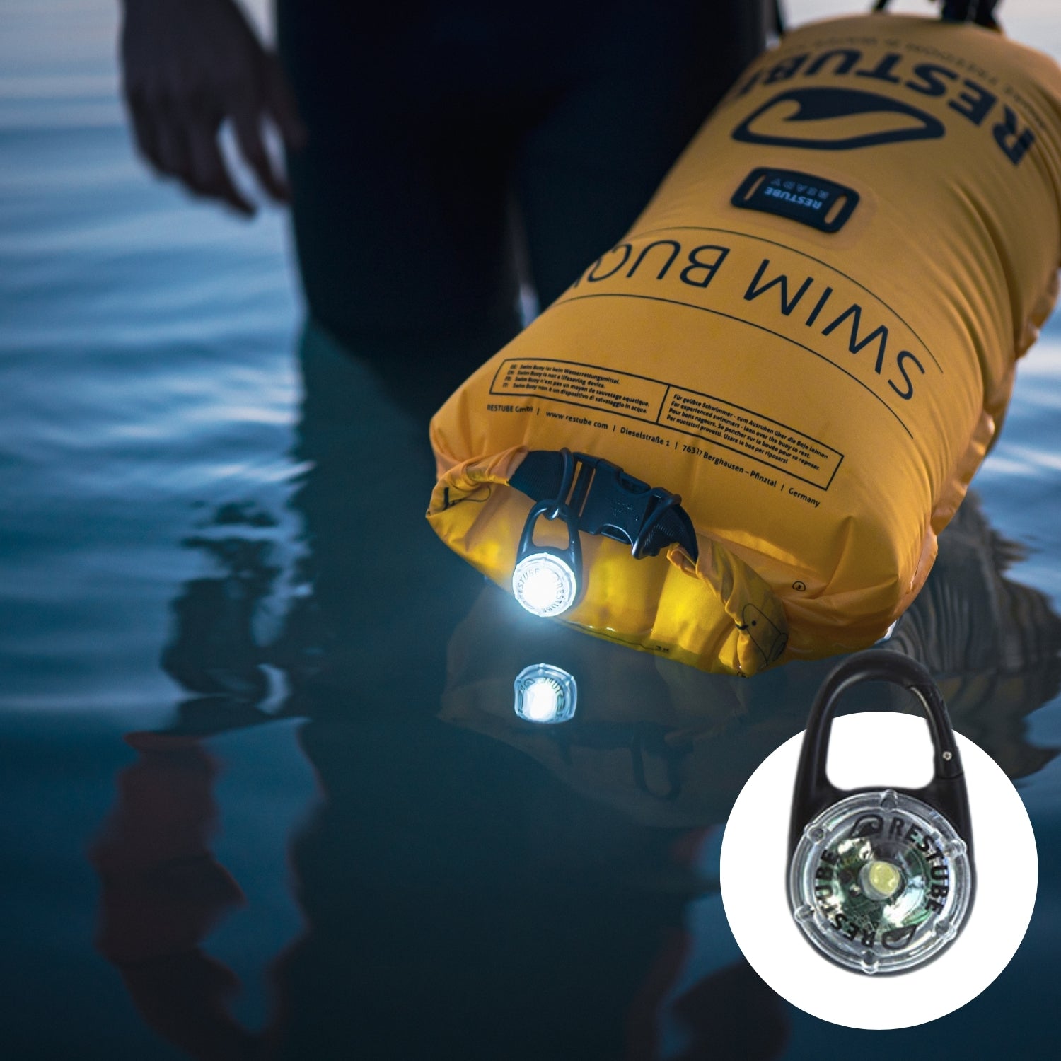 RESTUBE swim buoy with LED light in the water at dusk – for added safety.