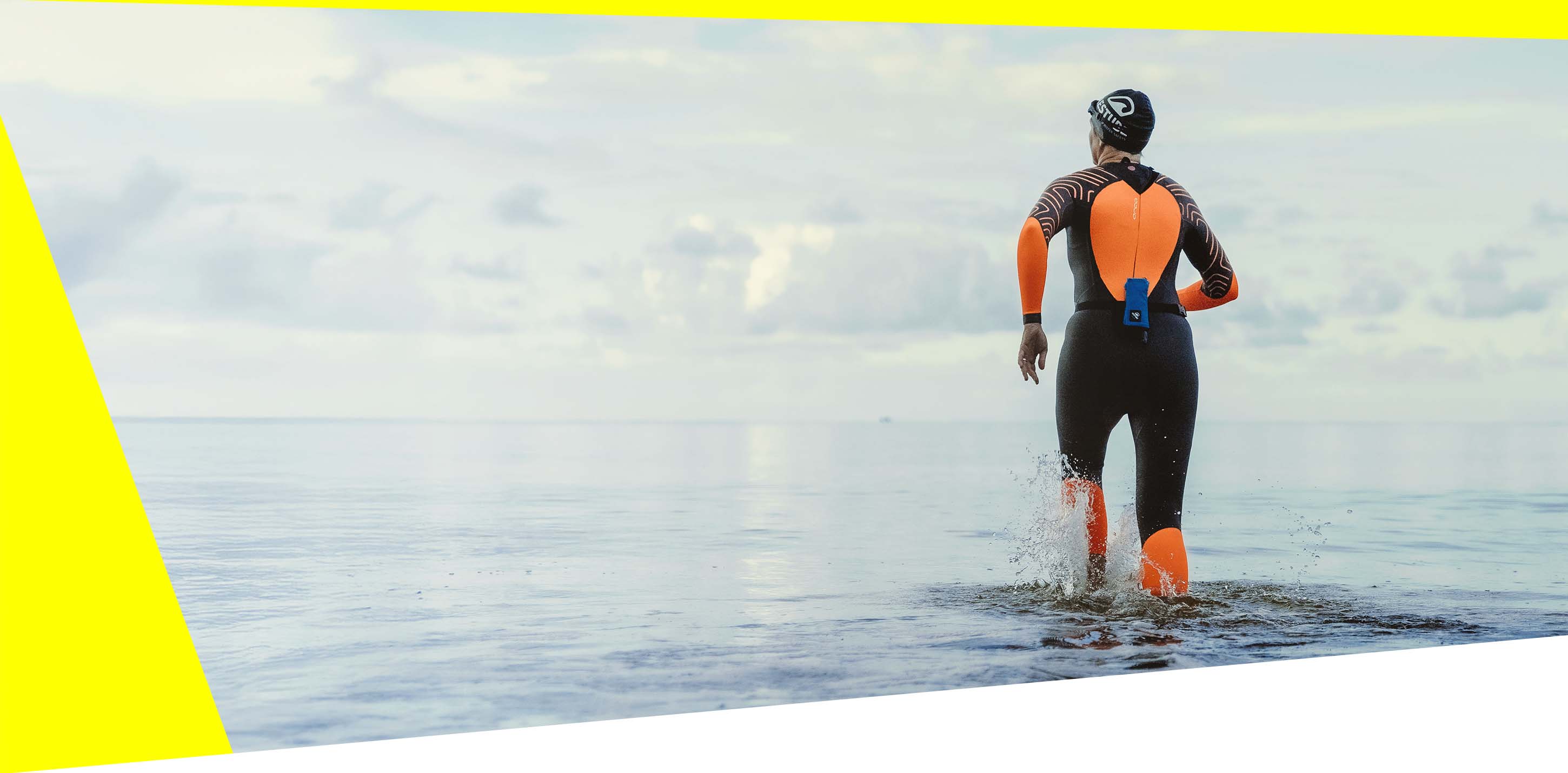 Swimmer with RESTUBE buoy in wetsuit during sunrise.