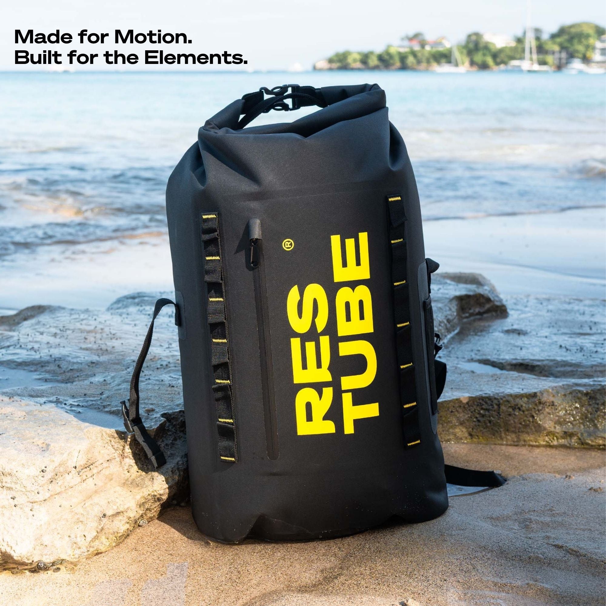 Black backpack with yellow 'RESTUBE' branding on a rocky beach