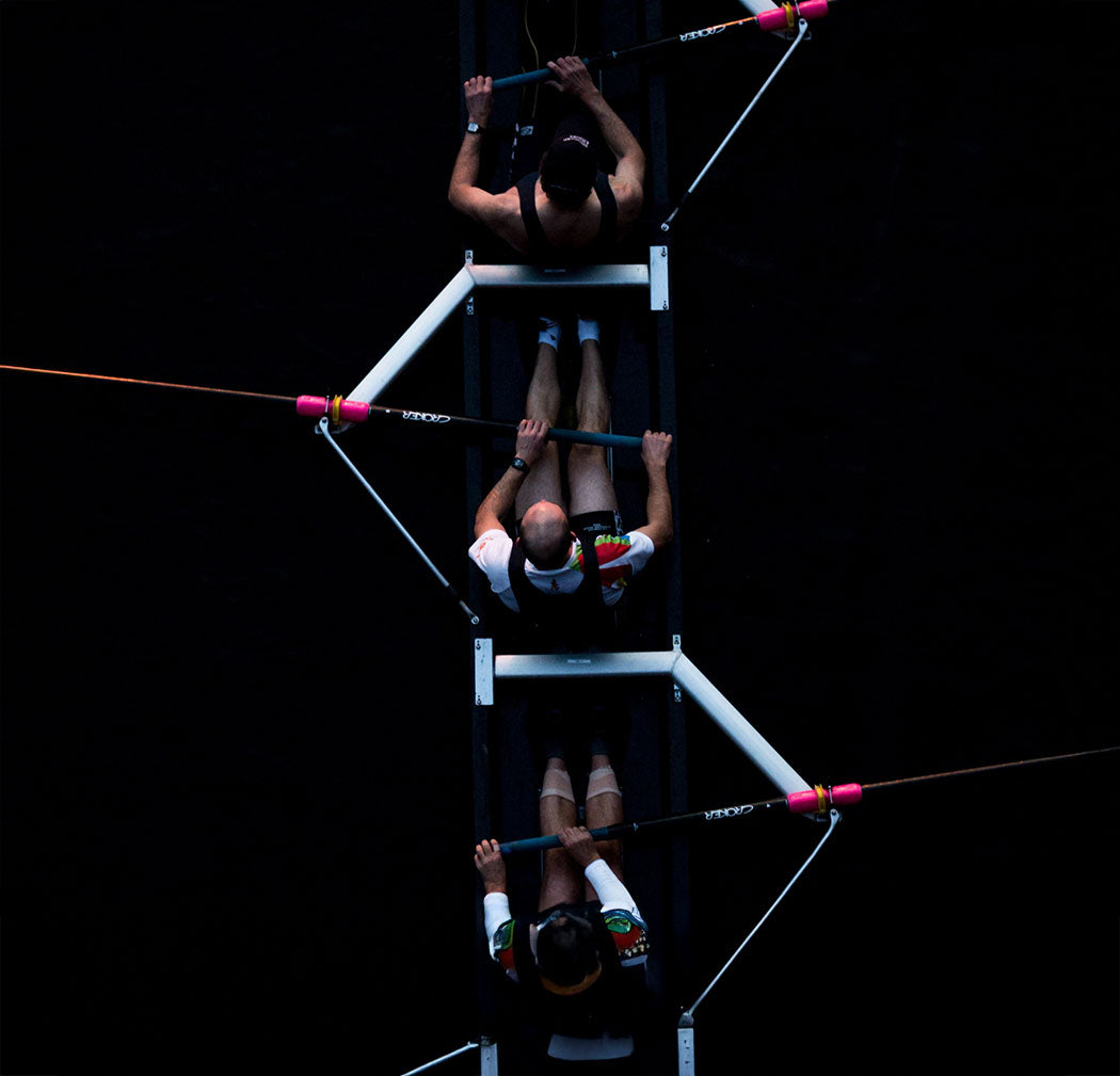 Rowing team on dark waters – symbolizes teamwork and water safety in sport.