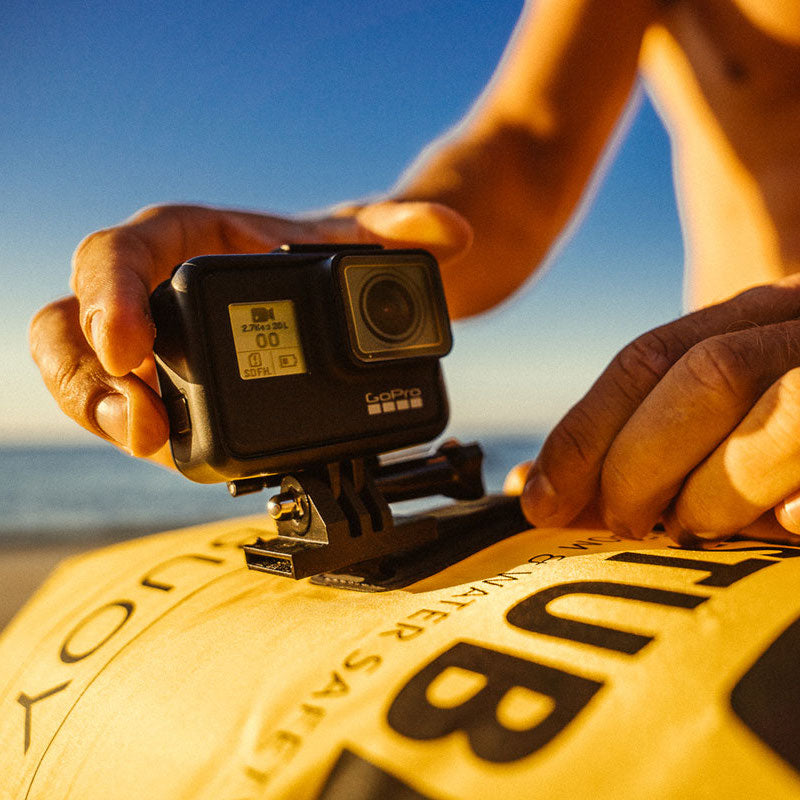 GoPro camera mounted on a RESTUBE buoy at the beach during sunset.