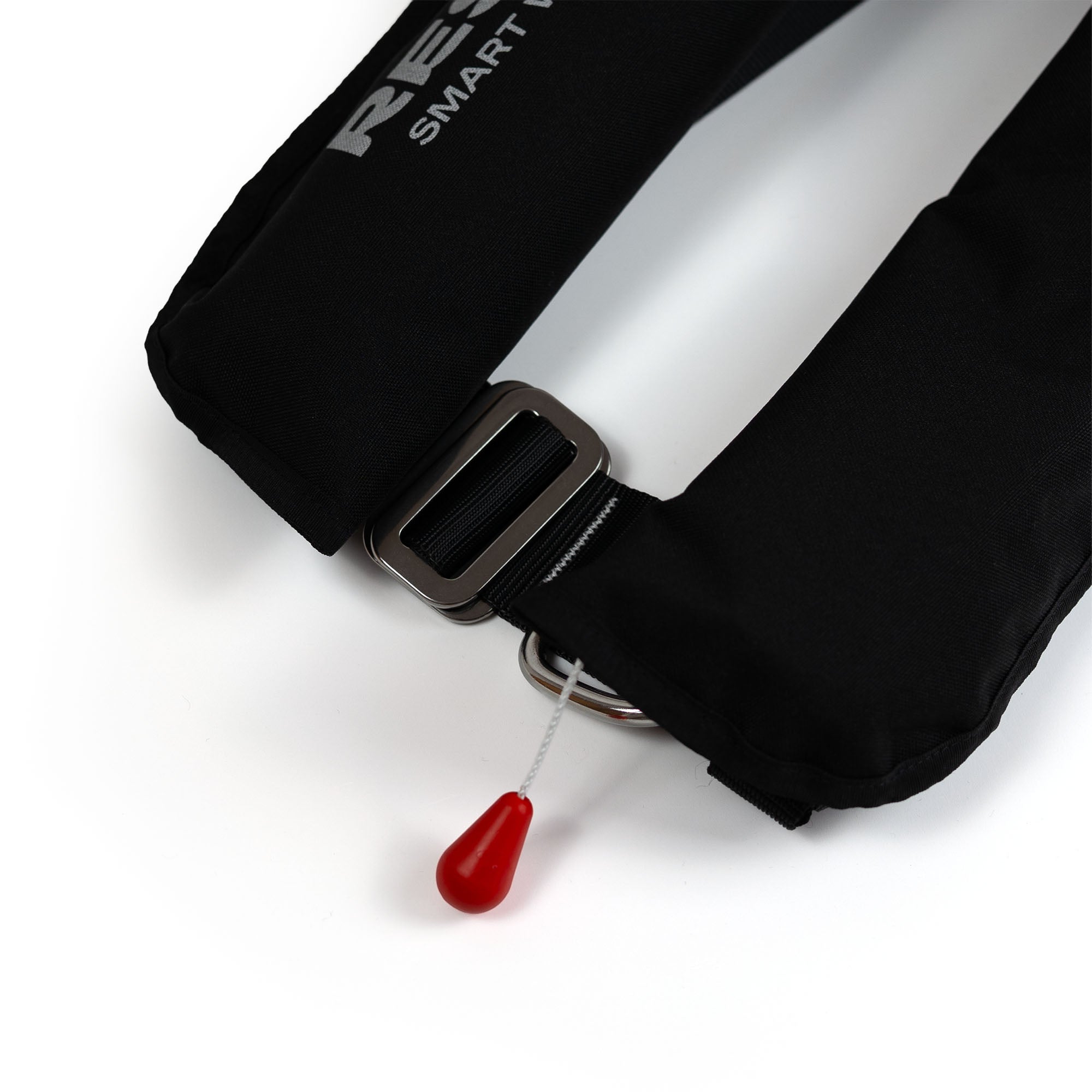 Close-up of plastic buckle and red pull cord trigger on inflatable life jacket