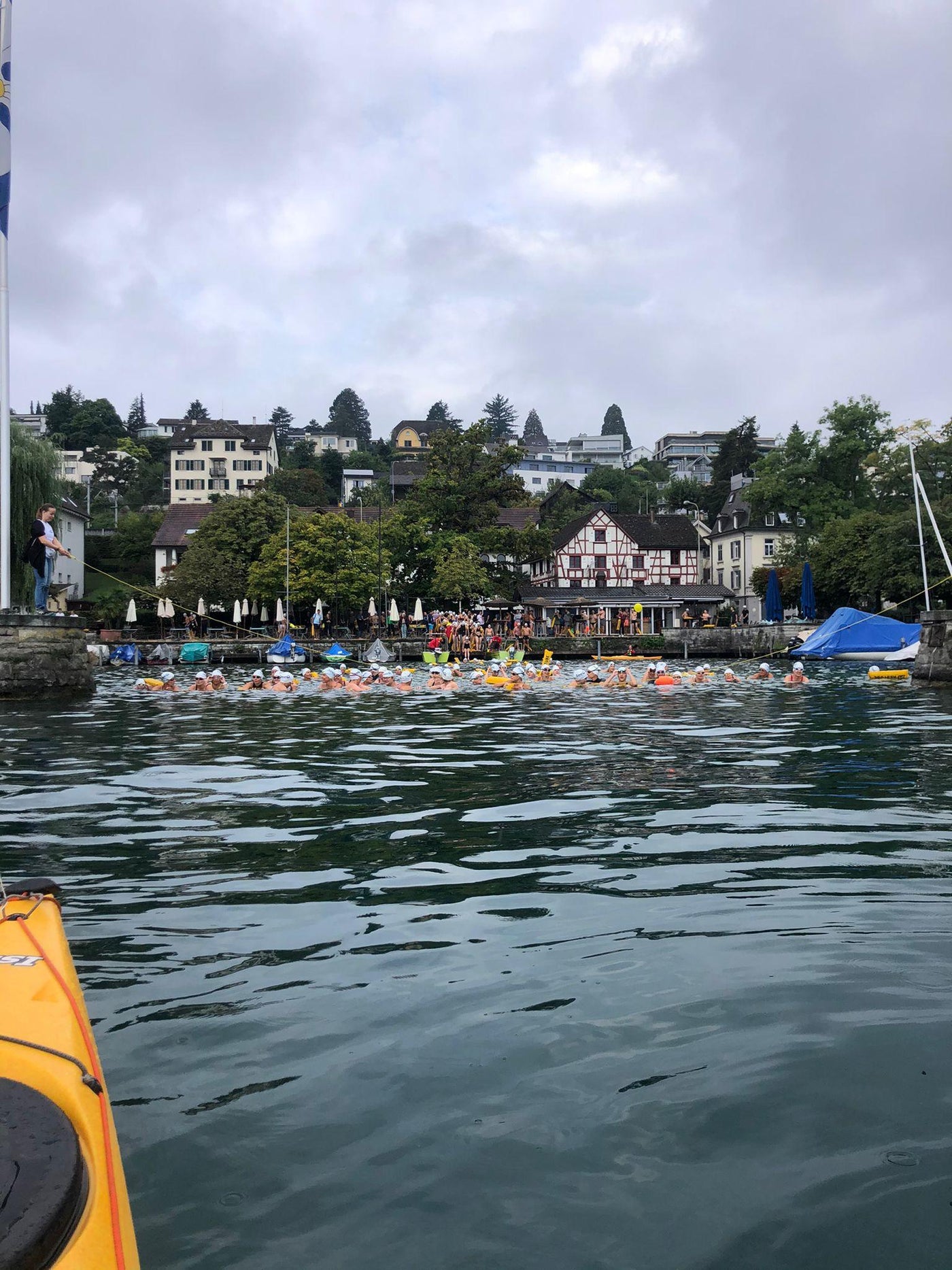 many people participating at an open water swim event in lake Zurich
