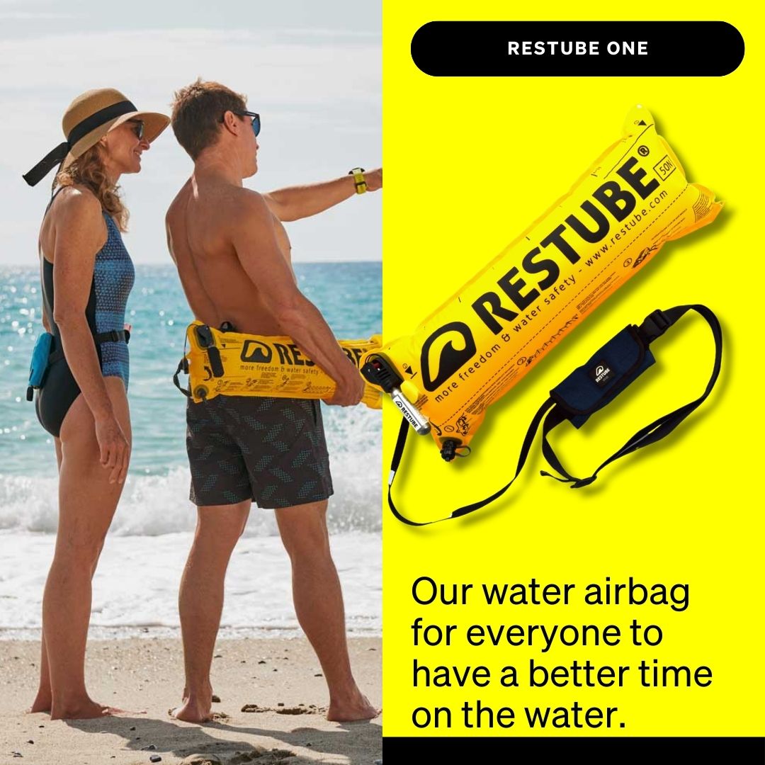 A woman and a man stand on the beach with RESTUBE ONE safety buoys at their waist; on the right, a yellow inflated RESTUBE ONE and the packed belt version are shown on a bright yellow background with the text “Our water airbag for everyone to have a better time on the water.”